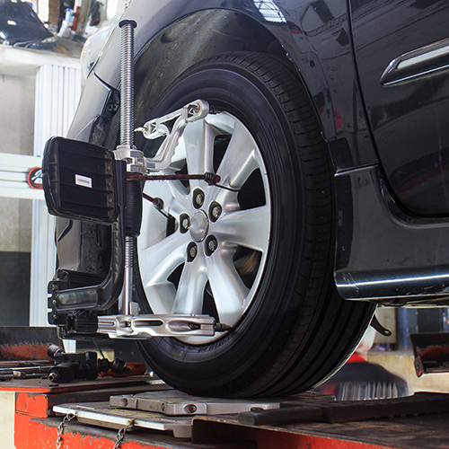 Wheel alignment service being performed at Auto Point Car Care in Apopka